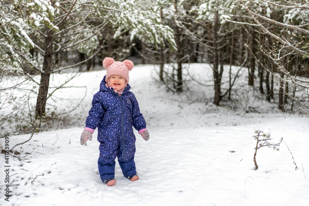 Happy baby girl in snowy country