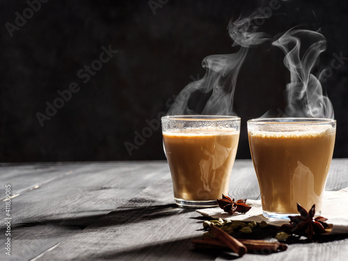Photography Two mugs of masala tea are on a gray table