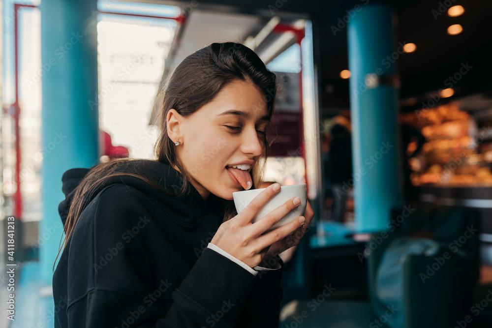 Close up portrait of pretty female drinking coffee. Close up portrait of pretty female drinking coffee.