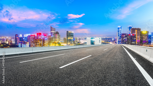 Asphalt road and modern city skyline with buildings in Hangzhou at night. © ABCDstock