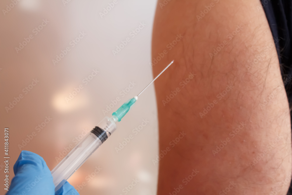 Female nurse holding syringe making covid-19 vaccination to man. Coronavirus vaccination concept. Female nurse holding syringe making covid-19 vaccination to man. Coronavirus vaccination concept.