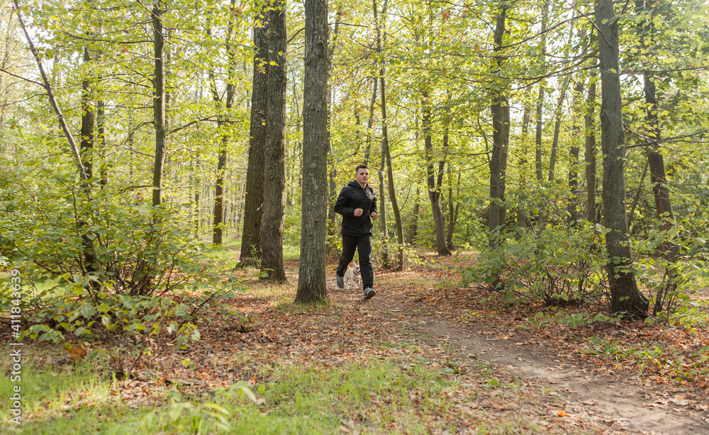 Sport Man runningon in forest. Healthy active man jogging Sport Man runningon in forest. Healthy active man jogging