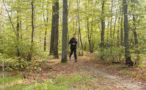Sport Man runningon in forest. Healthy active man jogging