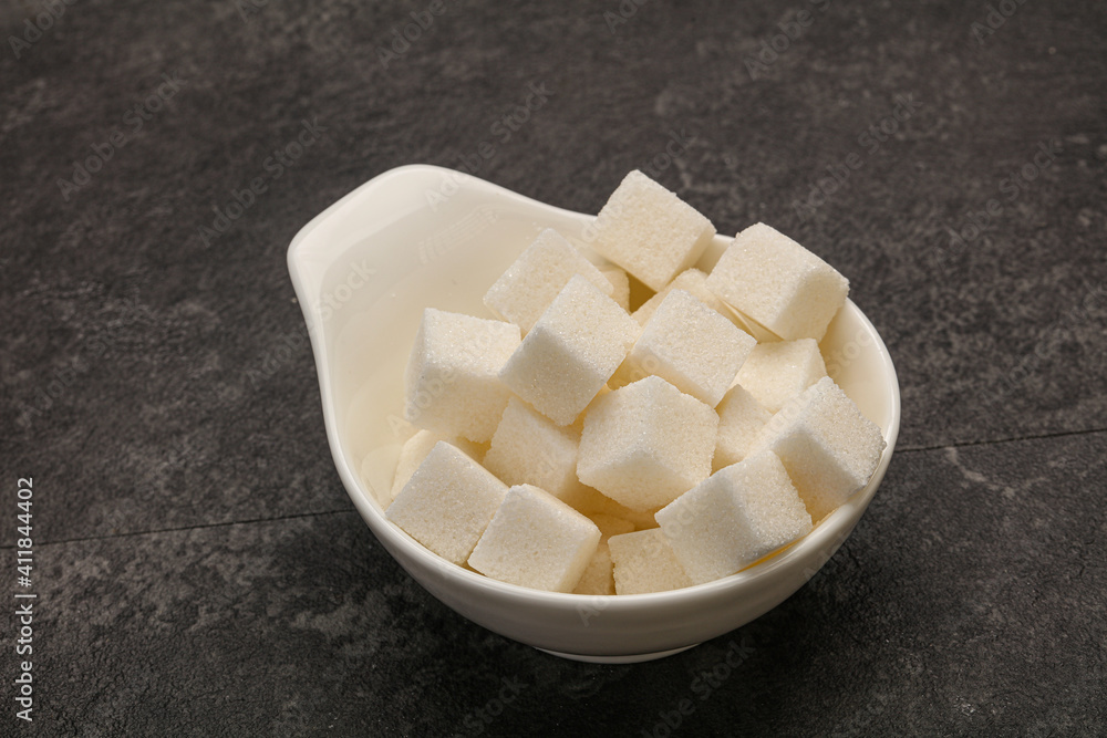 Refined white sugar cubs in the bowl Refined white sugar cubs in the bowl