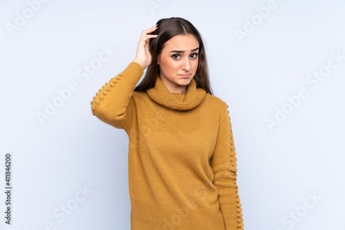 Young caucasian woman isolated on blue background with an expression of frustration and not understanding © luismolinero