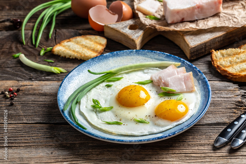 Delicious breakfast or lunch with fried eggs on wooden background, traditional Ukrainian or belorussian restaurant menu dish, food cooking recipe