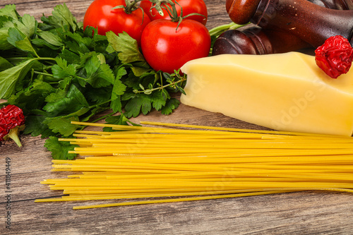 Raw Italian spaghetti heap with cheese