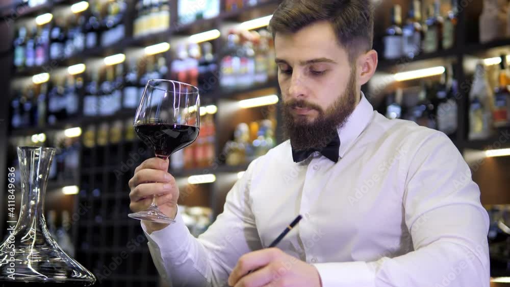 Young handsome man sommelier tasting red wine in cellar Young handsome man sommelier tasting red wine in cellar