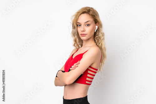 Young blonde woman isolated on white background keeping the arms crossed