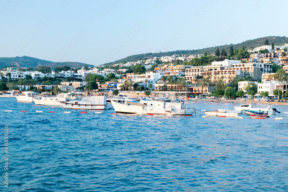 View of Bodrum Beach, Aegean sea,  white houses, marina, sailing boats, yachts in Bodrum town Turkey.