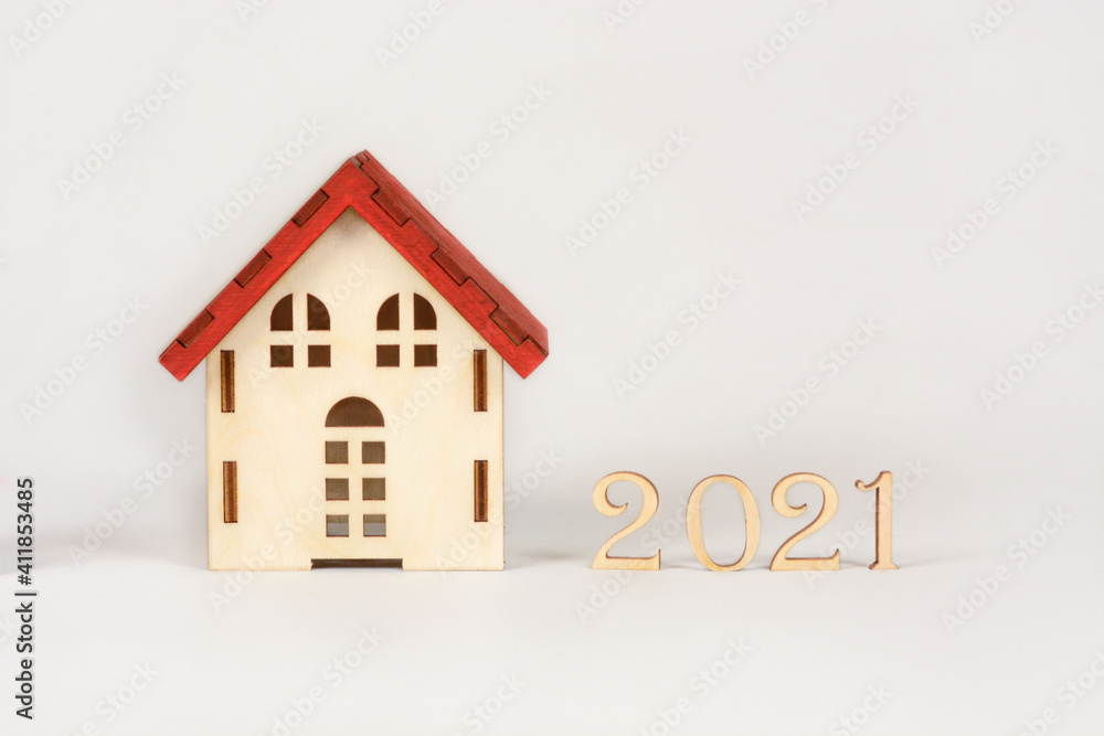 wooden house with an inscription from the signs of the numbers 2021. concept for lawyers, the adoption of new laws in suburban real estate wooden house with an inscription from the signs of the numbers 2021. concept for lawyers, the adoption of new laws in suburban real estate