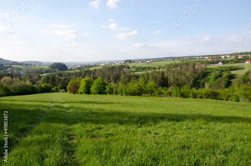 landscape with green grass and blue sky, Moravský Kras, Czech republic © Hana