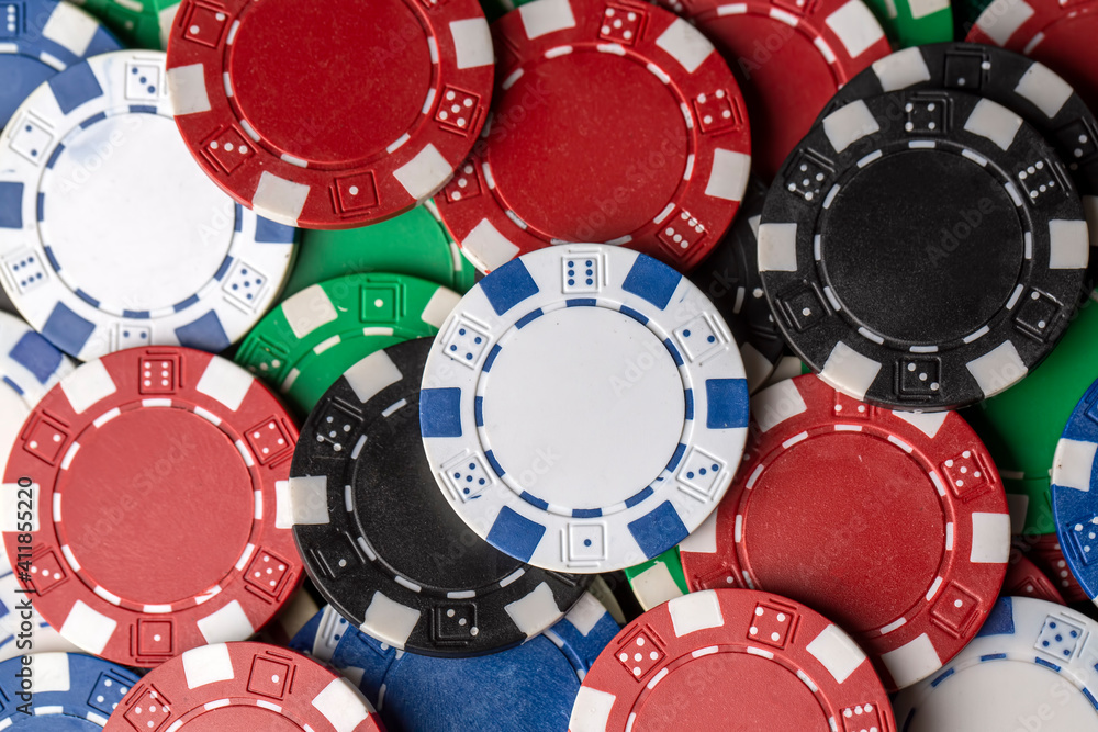 Colorful poker chips on green table. Gambling concept, background