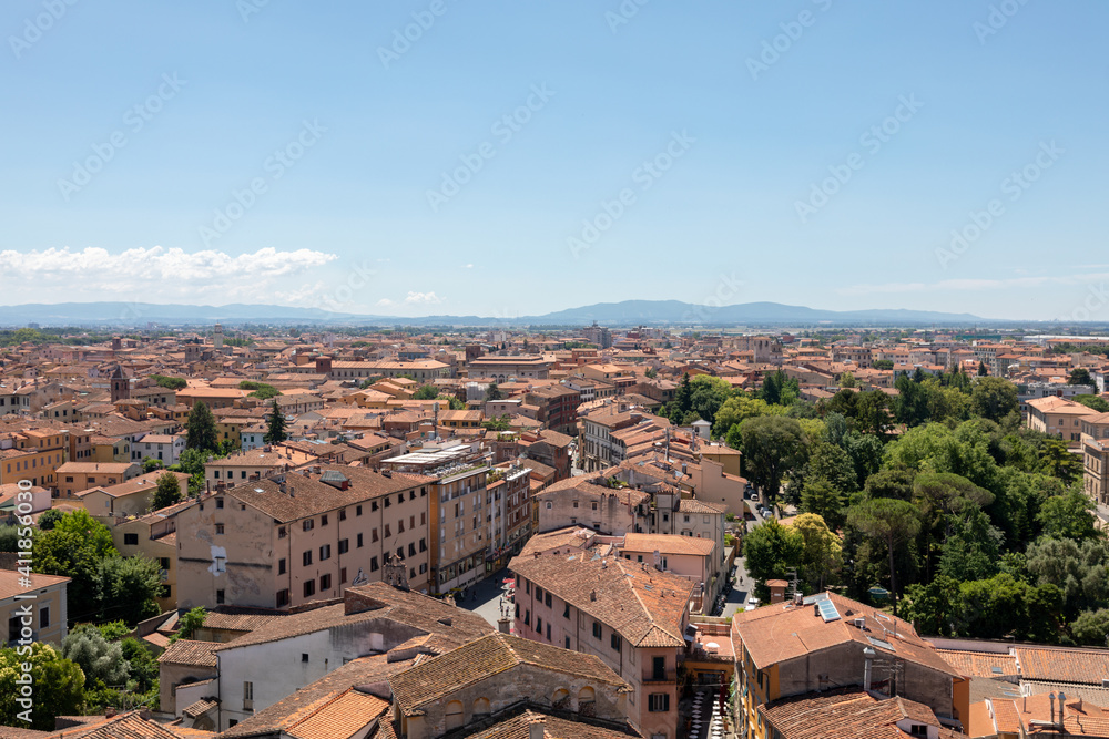 Panoramic view of Pisa city with historic buildings and far away mountains
