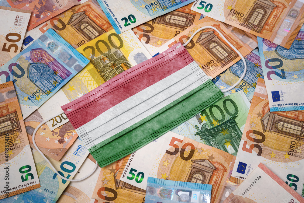 Medical mask with the flag of Hungary on a variety of european banknotes.(series) Medical mask with the flag of Hungary on a variety of european banknotes.(series)
