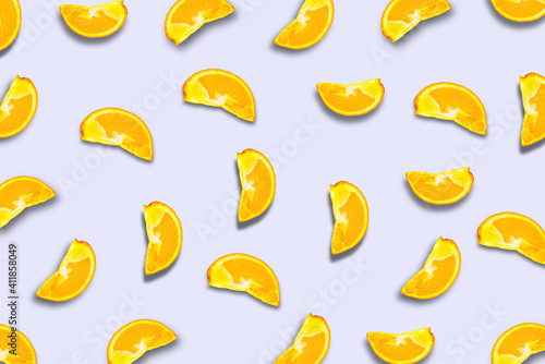 A pattern of orange slices with a shadow. Fruit background. © buena17