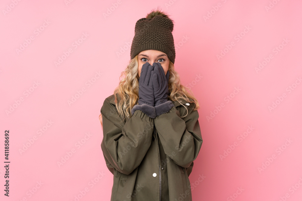 Young girl with winter hat isolated on pink background with surprise facial expression Young girl with winter hat isolated on pink background with surprise facial expression