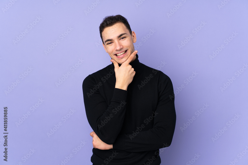 Young caucasian handsome man with turtleneck sweater isolated on purple background smiling Young caucasian handsome man with turtleneck sweater isolated on purple background smiling