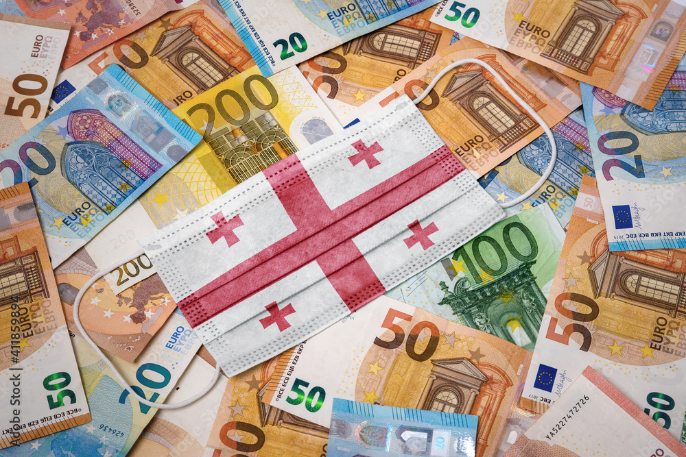 Medical mask with the flag of Georgia on a variety of european banknotes.(series) Medical mask with the flag of Georgia on a variety of european banknotes.(series)