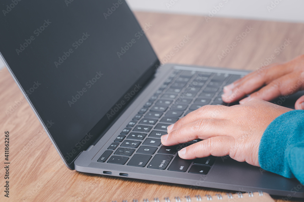 Female hand typing on computer keyboard of a laptop computer in office. Business and finance searching web, data analysis professional concept. Female hand typing on computer keyboard of a laptop computer in office. Business and finance searching web, data analysis professional concept.