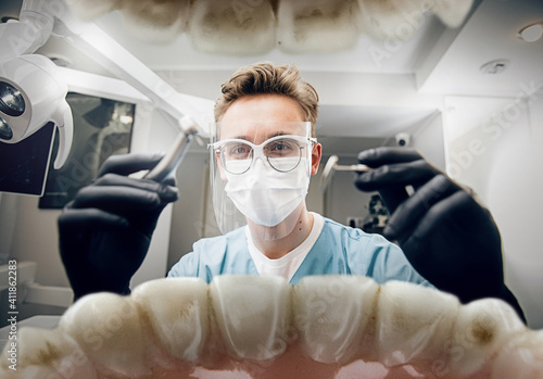 Medicine. Doctor looking into mouth, checking, examining teeth. Using professional tools and equipments. Healthcare and medicine, stomatology, feelings of patient. Look from inside the teeth.