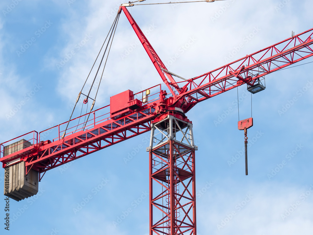 Construction crane or building crane on a construction site against blue sky