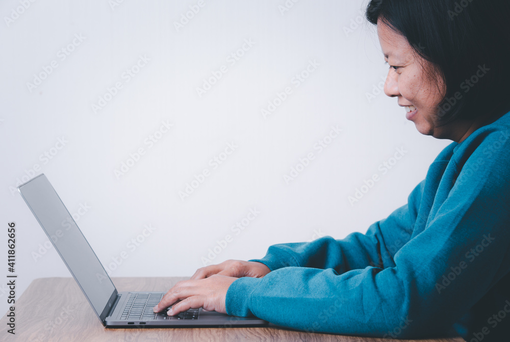 Naklejka premium Happy business woman using computer looking at screen working in internet sit at office desk, smiling female professional employee typing email on laptop at workplace business concept.
