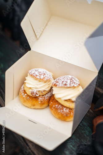 Traditional fastelavnsboller semla semlor swedish february dessert, traditional scandinavian sweet bread with almond cream paste and whipped cream. Cardamom bun and powdered sugar delicious treat