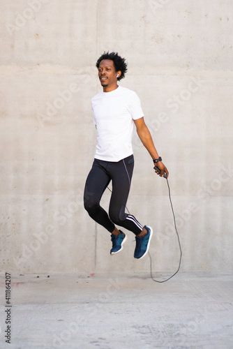 Afro athletic man doing exercise outdoors. photo