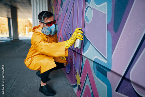 Wallpaper Mural Street artist painting colorful graffiti on wall Torontodigital.ca