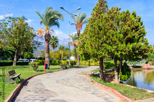 Pedestrian walkway and palm trees in Kugulu park in Kemer town, Turkey photo