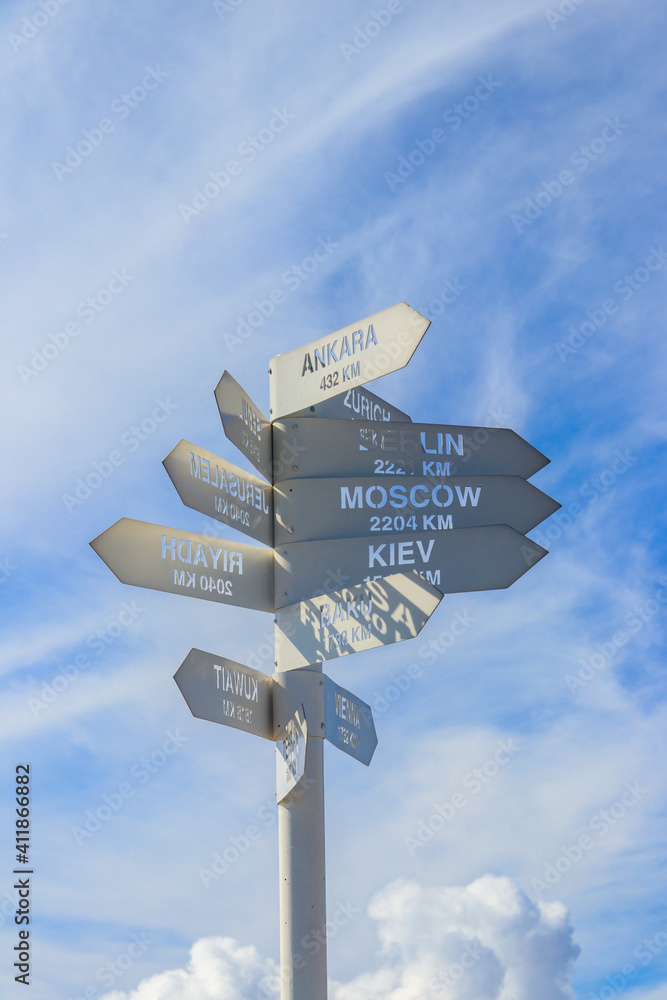 Sign indicating the directions and distances to major cities in the world on observation deck on a top of Tahtali mountain near Kemer, Antalya Province in Turkey Sign indicating the directions and distances to major cities in the world on observation deck on a top of Tahtali mountain near Kemer, Antalya Province in Turkey