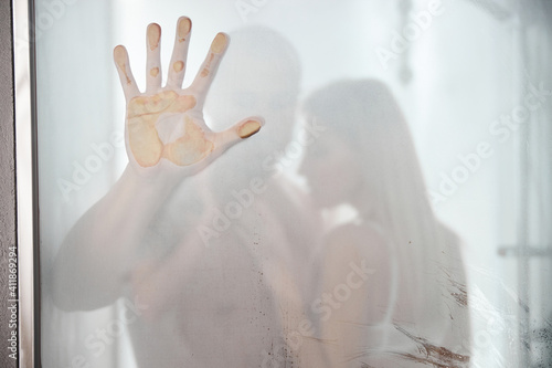 Married couple standing behind the steamy glass