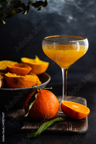 Freshly squeezed orange juice and halved oranges