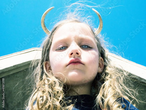 Portrait of a girl with devil horns