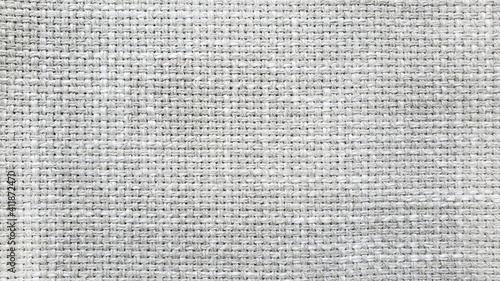light gray linen texture, burlap fabric as background. close up grey weaving or mesh fabric texture background. 