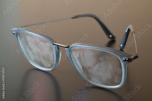 Tablou pe pânză Eyeglasses with fingerprints over the lenses,  smudged finger marks