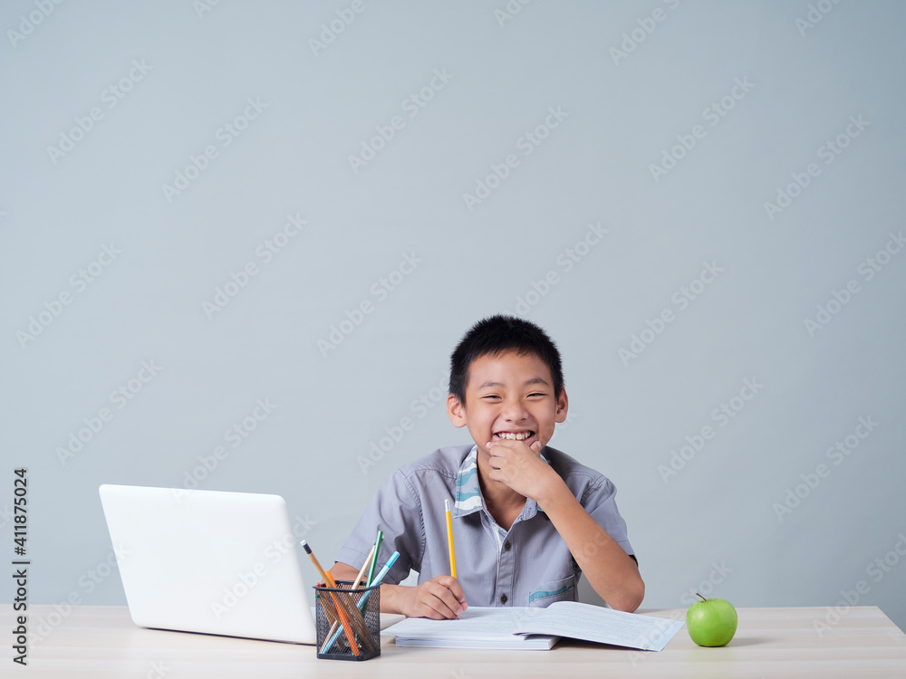 Little boy studying online with laptop Little boy studying online with laptop