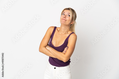 Young Russian woman isolated on white background making doubts gesture while lifting the shoulders