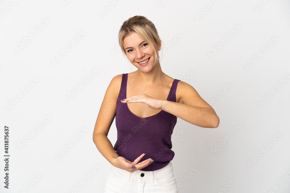 Young Russian woman isolated on white background holding copyspace imaginary on the palm to insert an ad Young Russian woman isolated on white background holding copyspace imaginary on the palm to insert an ad