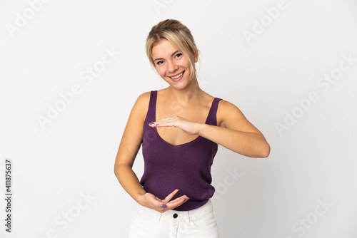 Young Russian woman isolated on white background holding copyspace imaginary on the palm to insert an ad