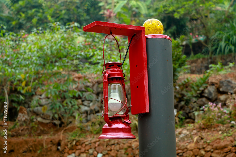 Red color electric lamp hanging on a pillar Red color electric lamp hanging on a pillar