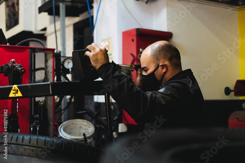 Obraz na plátně Auto mechanic working in garage. Repair service.