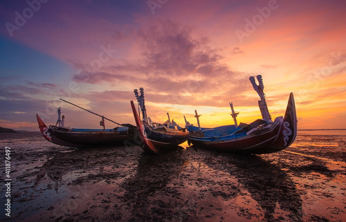 Three traditional boats on beach at sunset, Tuban, Bali, Indonesia
