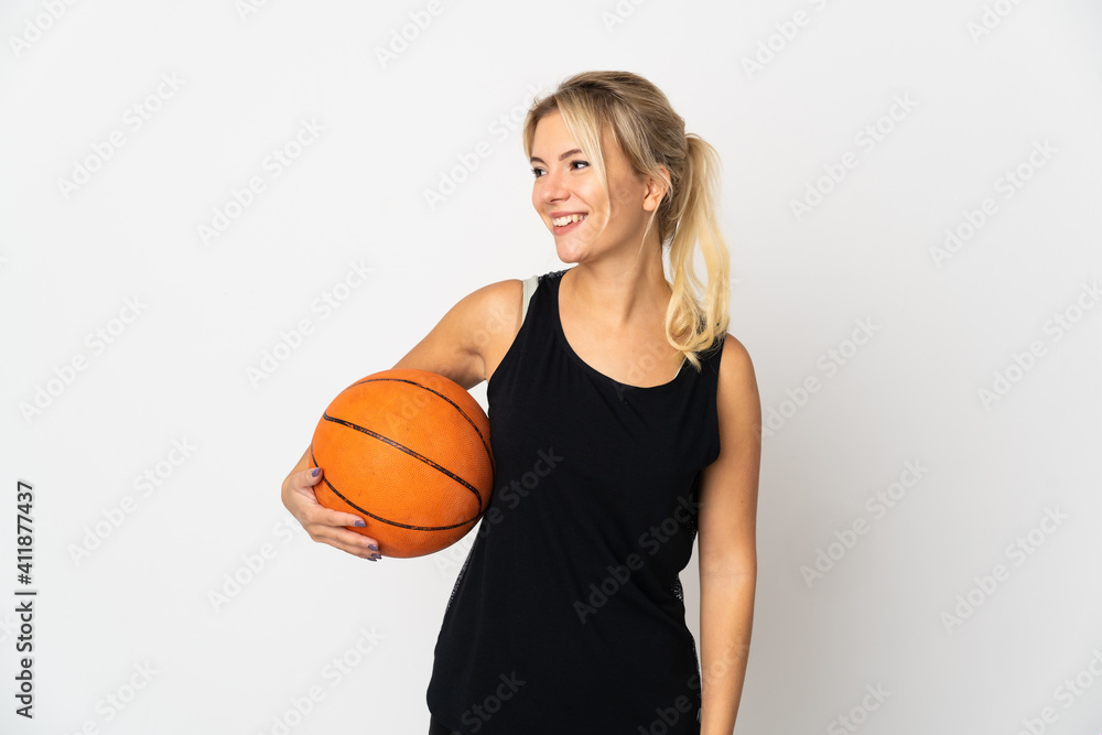 Young Russian woman playing basketball isolated on white background looking side Young Russian woman playing basketball isolated on white background looking side