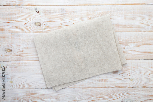 Empty canvas napkin on wooden desk top view, mockup