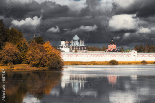 Tikhvin Bogorodichny Uspensky Male  Monastery in Russia Leningrad region  against a dramatic sky photo