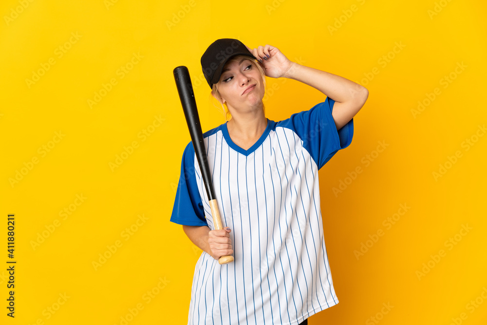 Young Russian woman isolated on yellow background playing baseball and having doubts with confuse face expression Young Russian woman isolated on yellow background playing baseball and having doubts with confuse face expression