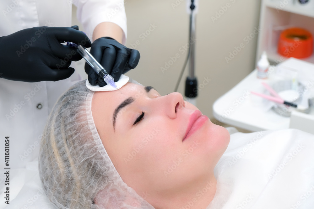 Cosmetic injections for skin rejuvenation. Cosmetologist injects a syringe into the skin Cosmetic injections for skin rejuvenation. Cosmetologist injects a syringe into the skin