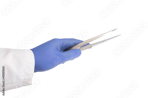 Doctor's hand in a medical glove holds a medical instrument tweezers for an operation on a white background, isolate.